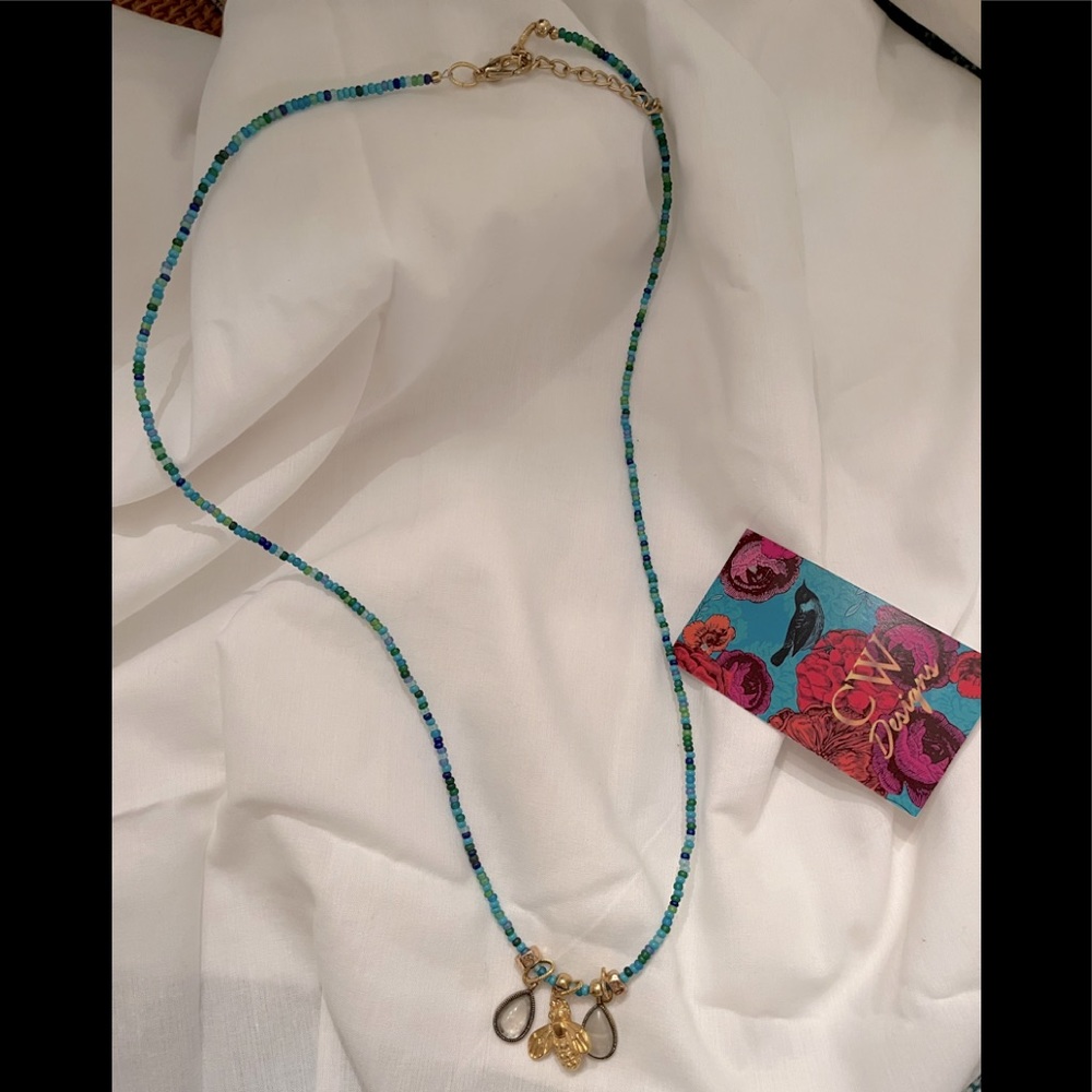 Turquoise colored necklace with gold tone bee charm